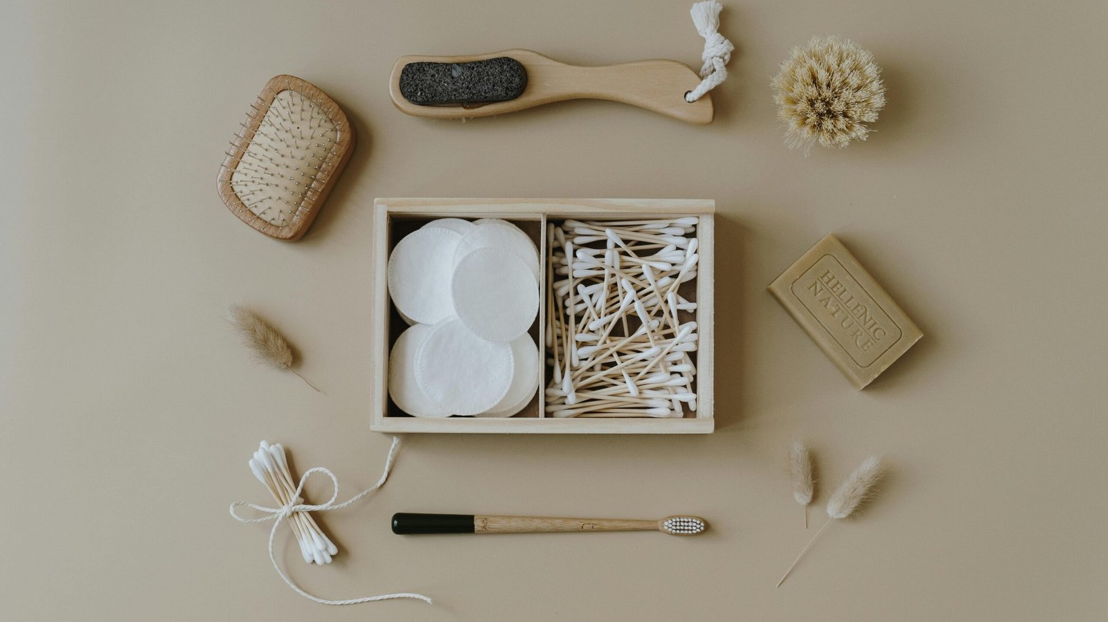 Flat lay of eco-friendly bath products including brushes and cotton buds for sustainable living.